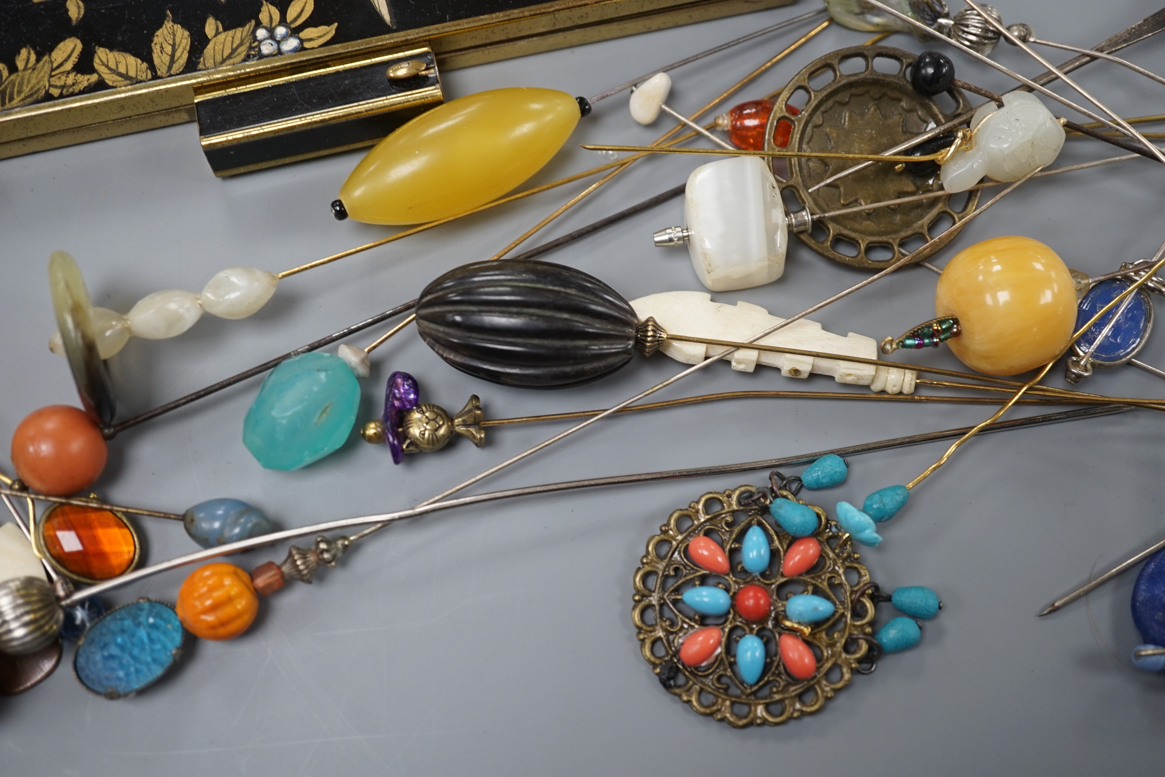 A quantity of hat pins and a compact
